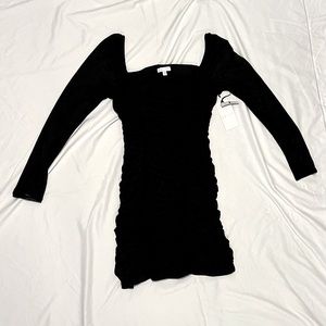 Little black dress. Brand New. Ruched with Sheer long sleeves.